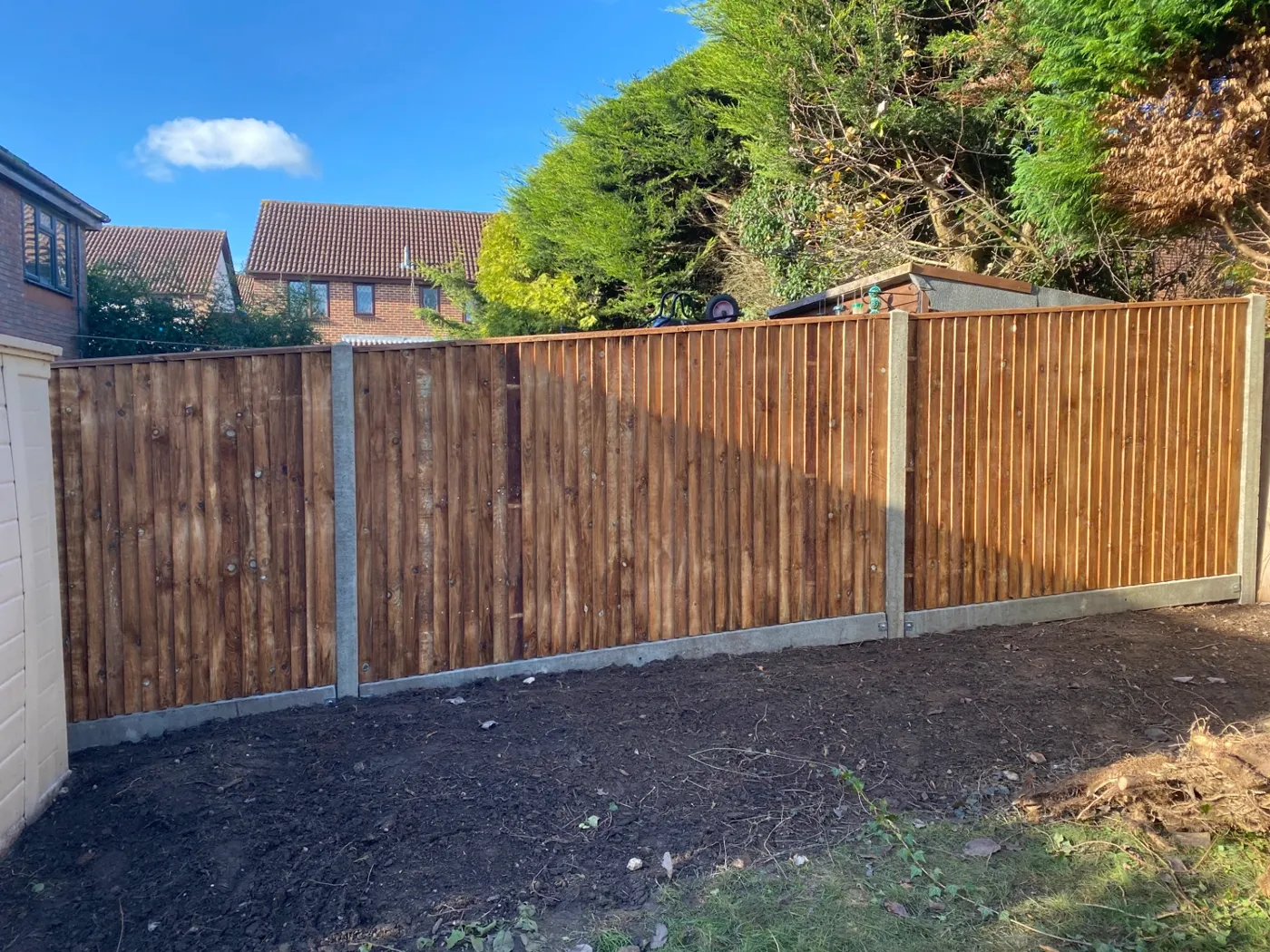 New closeboard fence with concrete posts and gravel boards garden